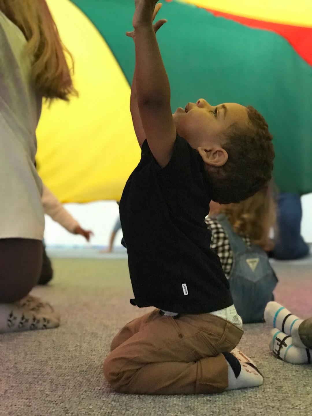 Boy reaching for parachute